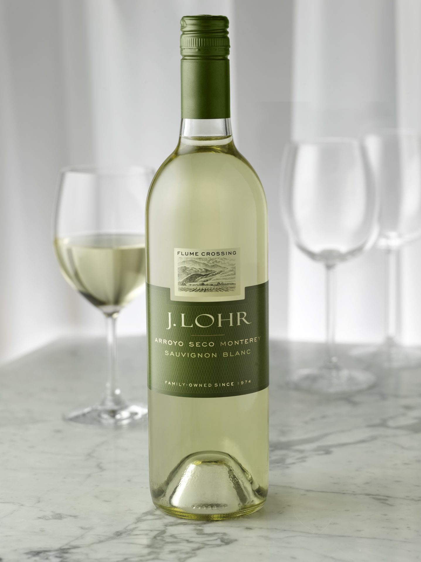 https://www.spiritedbiz.com/wp-content/uploads/2021/01/J.-Lohr-Estates-Flume-Crossing-Sauvignon-Blanc-with-wine-glasses.jpg